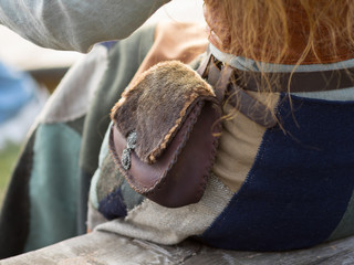 The bag or small wallet is made in the ancient style of leather and wool, attached to the belt