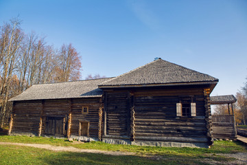 large old log house in autumn in the village standing on the lawn
