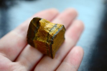 Tigers Eye Healing Crystal Pendant. Courge, Confidence Booster Necklace. Bronze & Gold. Lovely healing polished tigers eye. Macro photo of crystal with bright lighting.