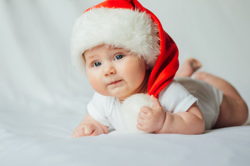 Cute little baby in santa hat on white background