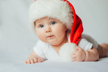 Cute little baby in santa hat on white background
