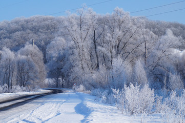 Beautiful winter landscape at sunset with fog and snow