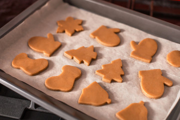 Preparing ginger christmas cookies in oven
