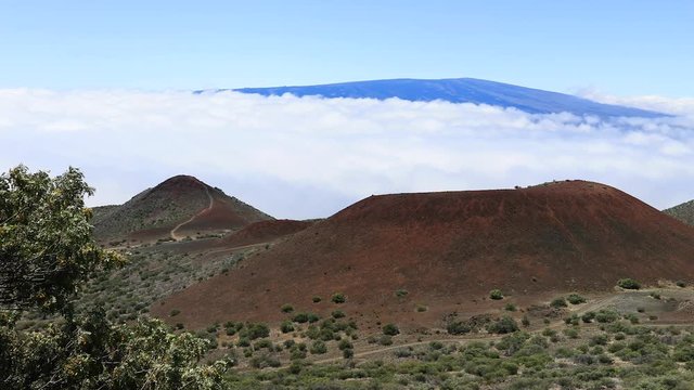 Mauna Loa volcano from Mauna Kea Hawaii above clouds. Mauna Kea Observatories, MKO, astronomical research facilities and large telescope. NASA and international partners.
