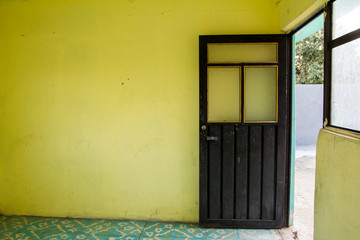 Yellow room with open black steel door