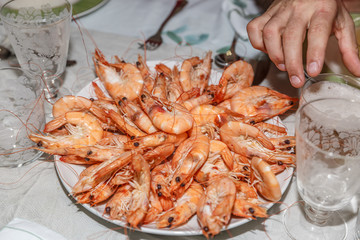 Close-up of a large plate of freshly cooked and appetizing prawns on a table ready for a  celebration