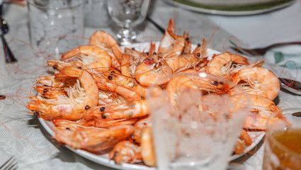 Big plate of freshly cooked prawns ready to eat, on a table prepare for a celebration