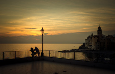 Couple admires the sunset on the sea