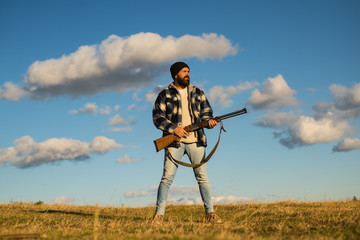 Hunting without borders. Hunter with shotgun gun on hunt. Closed and open hunting season.
