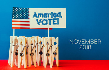 clothespins as illusion people, banners with text - november  VOTE, Flag of the USA on patriotic...