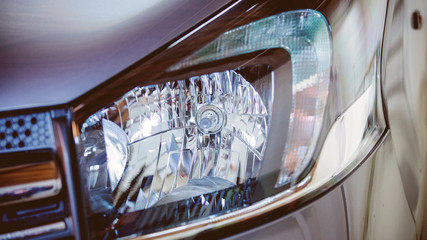 Fototapeta premium closeup view at modern car headlight. Front view