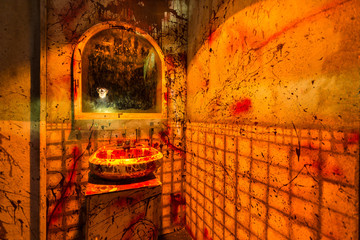 Bloody bathroom scene gory walls and a floating terrifying mask in the mirror