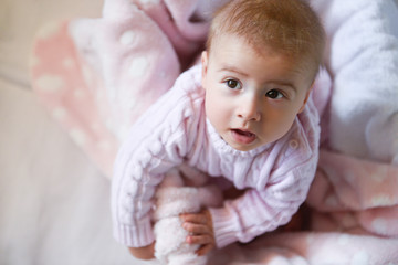 Portrait of baby girl posing in pink clothes