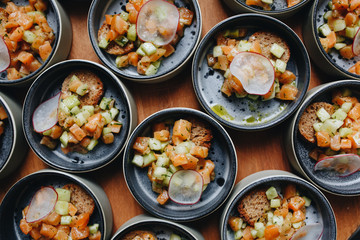 salmon Tartar with avocado in small plates for Banquet.
