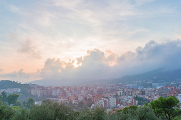 Obraz premium Barcelona view from Guell park sunset cloudy sky
