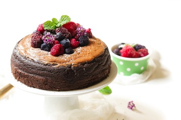 Homemade Chocolate cake topped with fresh fruits and cocoa buttercream frosting