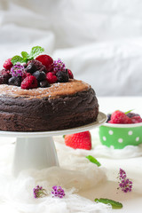 Homemade Chocolate cake topped with fresh fruits and cocoa buttercream frosting
