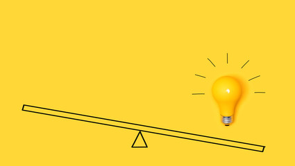 Idea light bulb on a scale on a yellow background