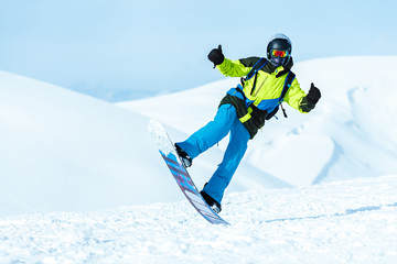 Extreme snowboard rider posing in the mountains
