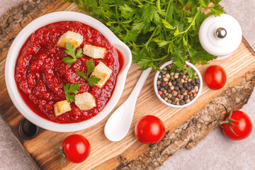 Bright fresh tasty pureed tomato soup with ingredients