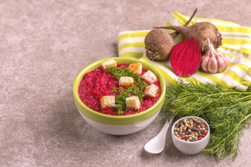 Bright tasty pureed beetroot soup with ingredients. Healthy food