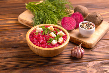 Bright tasty pureed beetroot soup with ingredients. Healthy food