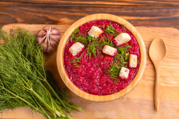 Bright tasty pureed beetroot soup with ingredients. Healthy food