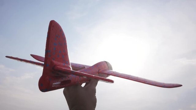 Male boy play with toy airplane in summer fields