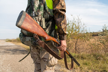 Hunters with a german drathaar and spaniel, pigeon hunting with dogs in reflective vests	