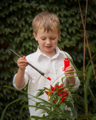 Boy Painting Peppers in the Garden