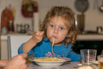 Little girl eating spaghetti 