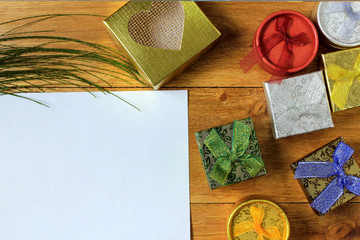 Christmas composition. Christmas gifts on wooden table. Top view, empty space, cardboard