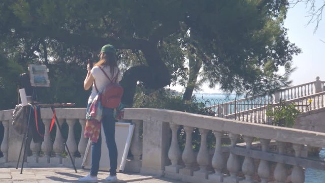 The artist photographing her painting in Venice