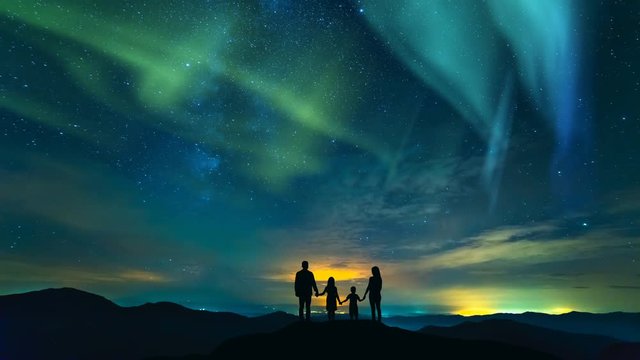 The family standing on a background of a city with a northern light. time lapse