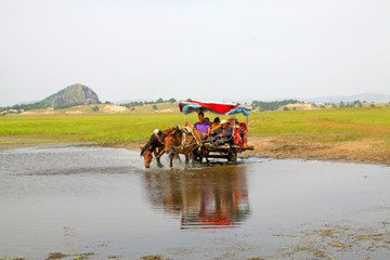 Obraz premium carriage traveling in the water, WuLanBuTong grassland, China