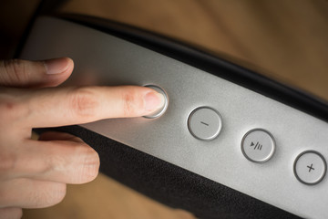 Close up woman hand control music player for relaxing on holiday.