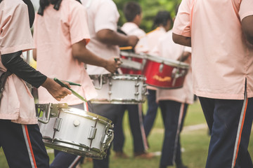 Marching band drummers perform in school parade