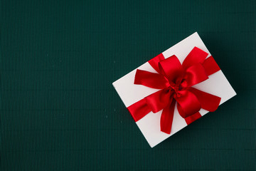 Gift Box with Ribbon on green paper