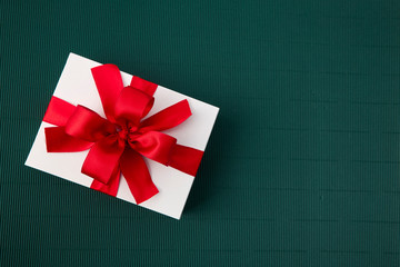 Gift Box with Ribbon on green paper