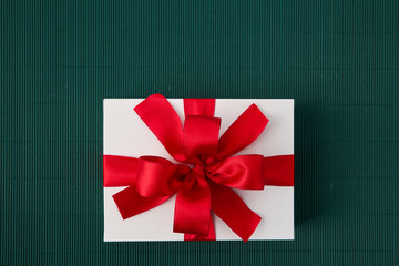 Gift Box with Ribbon on green paper