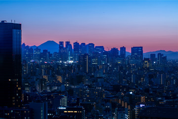 Fototapeta na wymiar view of tokyo skyscraper twilight with MT.fuji sunset