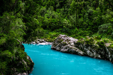 Hokitika Gorge, West Coast, New Zealand. Beautiful nature with blueturquoise color water and wooden swing bridge.