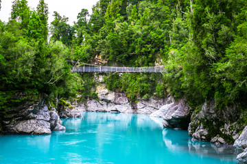 Hokitika Gorge, West Coast, New Zealand. Beautiful nature with blueturquoise color water and wooden swing bridge.