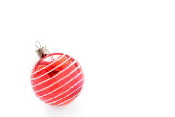 Christmas tree decoration isolated on a white background, red glass ornamental ball. Space for text for Christmas card.