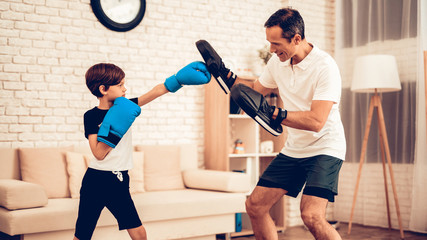 Little Boy in Boxing Gloves and Man in Apartment.