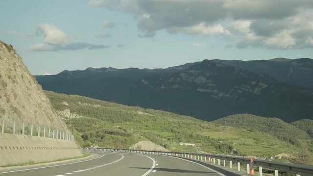 Baga, Spain. Cars Driving In Beautiful Asphalt Freeway, Motorway, Highway E-9, C-16 Against The Background Of Southern Pyrenees Mountains Landscape