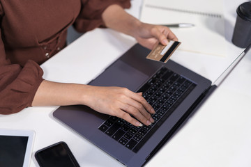 Fototapeta na wymiar hands holding credit card and using laptop for online shopping