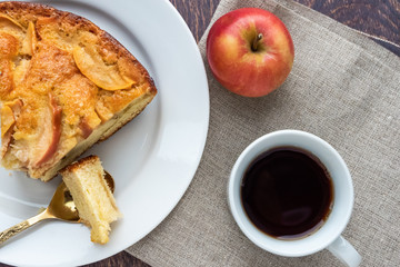 Tea and piece of apple pie on a plate. Top view.