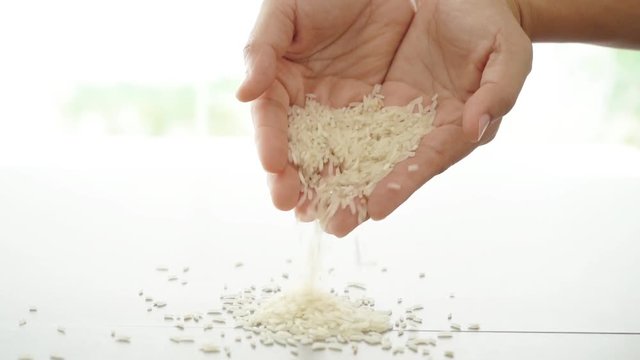Pouring white rice from the palm