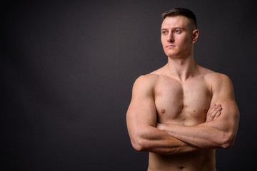 Fototapeta premium Handsome muscular fitness man shirtless with arms crossed thinking